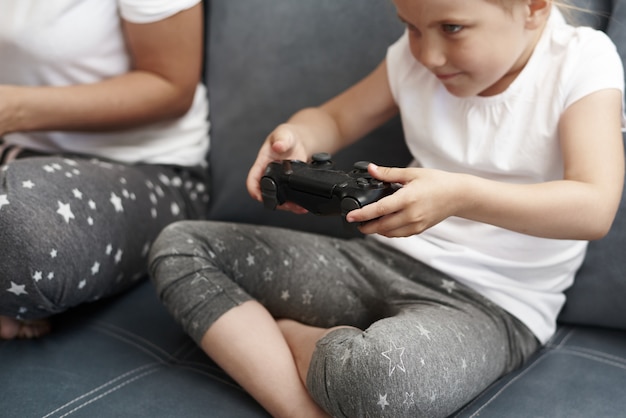 Mother And Daughter Are Playing Computer Game A Little Girl Is Playing