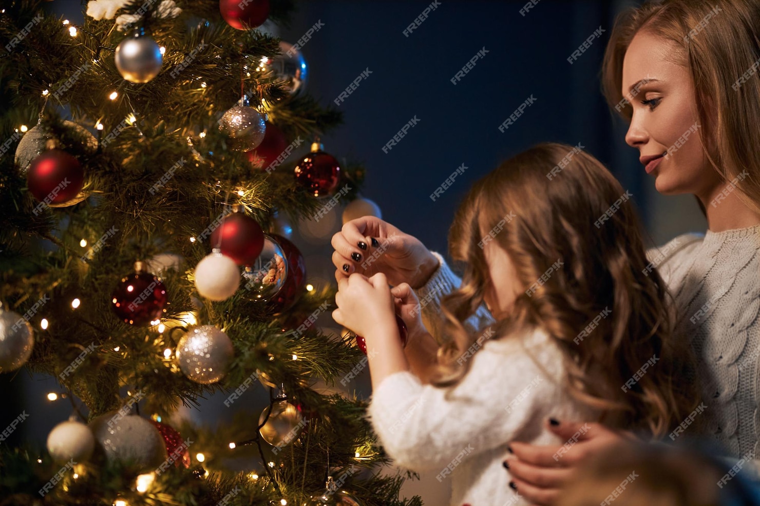 Free Photo | Mother and daughter decorating christmas tree together