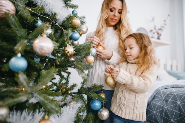 Free Photo | Mother and daughter decorating the tree