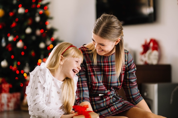 Free Photo | Mother and daughter laughing at christmas