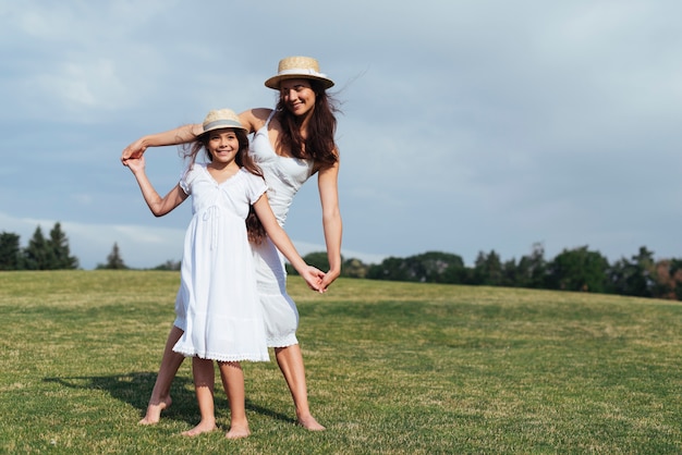 Free Photo | Mother and daughter posing outdoors