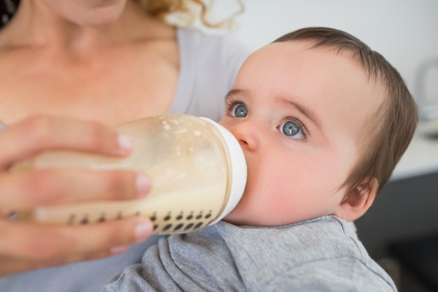 Premium Photo | Mother feeding milk to baby