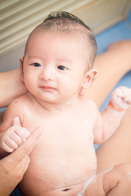 Premium Photo Mother Give A Bath Her Newborn Baby Infant