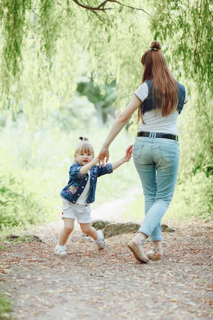 Download Mother playing with her daughter holding hands Photo ...