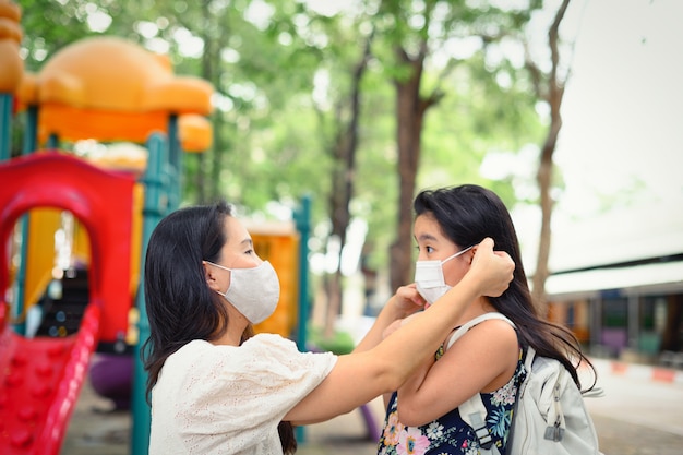 Mother Puts A Safety Mask On Daughter Face For Protection Coronavirus
