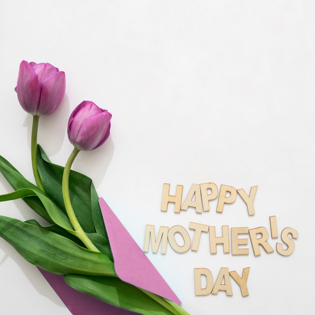 Free Photo | Mother's day lettering and purple roses in envelope