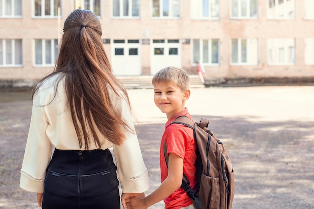 Premium Photo | Mother and small children first-grader going to school ...