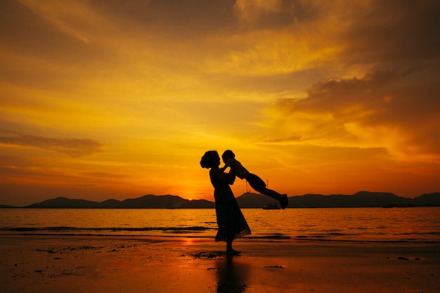 Premium Photo | A mother and son in outdoors at sunset with copy space