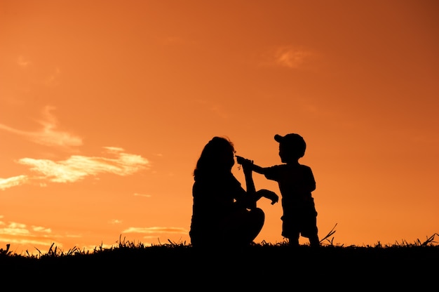 Premium Photo A Mother And Son Playing Outdoors At Sunset 4770