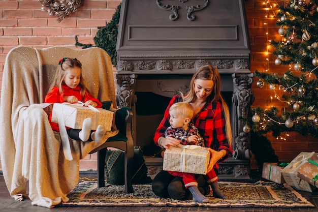 Free Photo | Mother with children by christmas tree