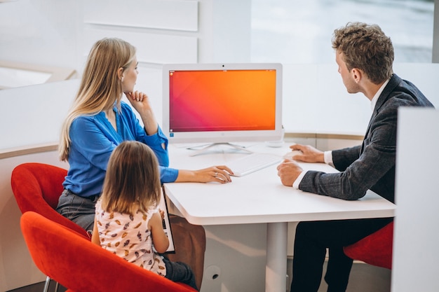 Mother with daughter buying a car in a car showroom Free Photo