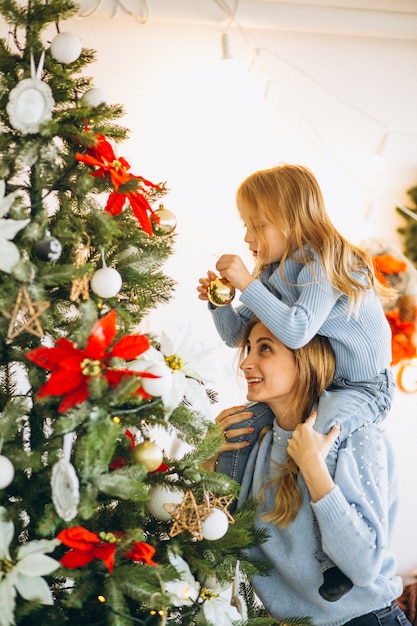 Free Photo | Mother with daughter decorating christmas tree