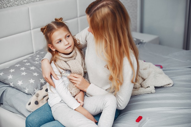 Mother with her illnes daughter in a bedroom