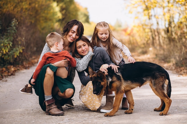 秋の公園で犬と子供を持つ母 無料の写真