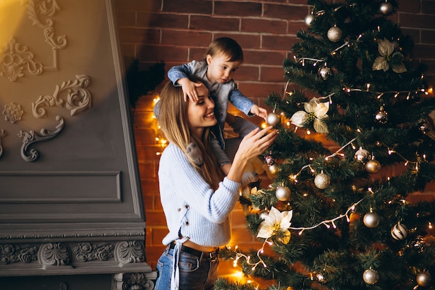 Free Photo | Mother with little daughter decorating christmas tree