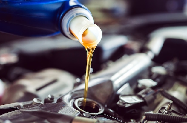 Premium Photo | Motor oil pouring to car engine.