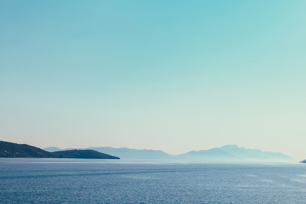 Premium Photo Mountain Chain Across The Seashore Of Aegean Sea In Greece Landscape That Combines Mountains Sea Blue Sky And Day Light Sky Blue Calming Color Meditation Atmosphere