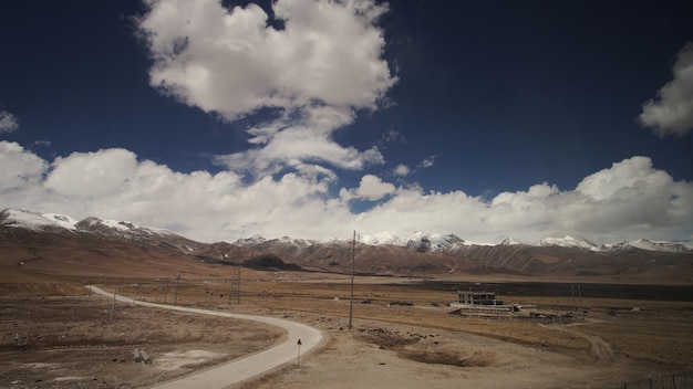 Mountain and land with some of clouds and sky with high contrast Premium Photo