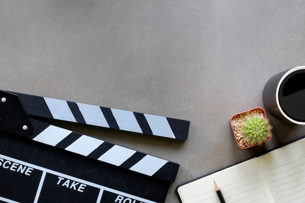 Premium Photo Movie Clapper With Notepad Paper Cup Of Coffee Cactus On Director Table Top View And Copy Space