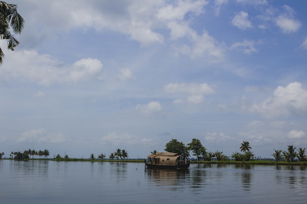 Moving house boat on a river Free Photo