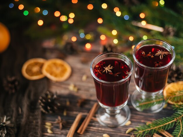 Premium Photo | Mulled wine in glasses on a wooden background with ...