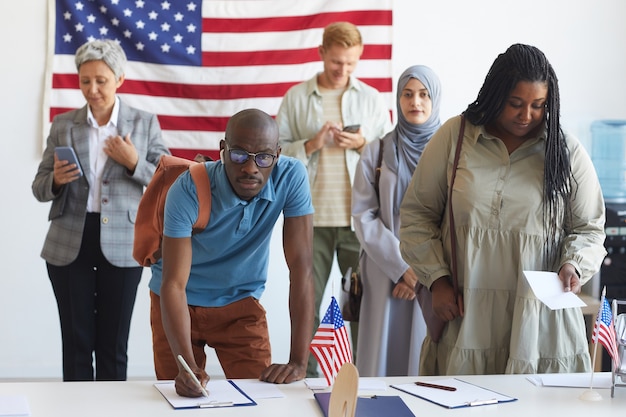 Premium Photo | Multi-ethnic group of people registering at polling ...