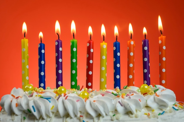 Premium Photo | Multicolored candles burn on a birthday cake