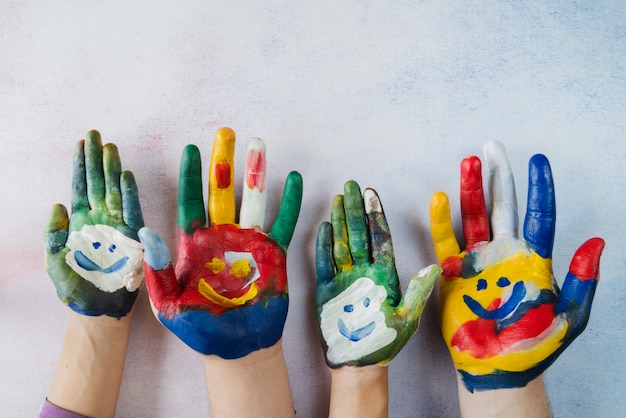 Multicolored Palms With Painted Smiling Faces 