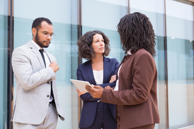 Free Photo | Multiethnic partners discussing partnership outside