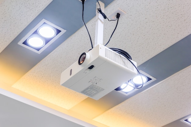 Multimedia Projector Hanging On The Ceiling Of Modern