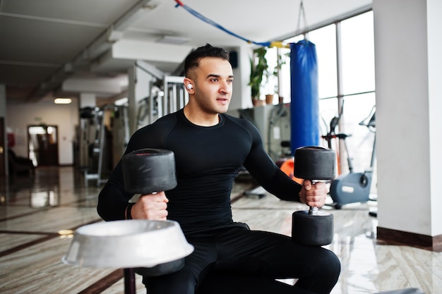 Premium Photo Muscular Arab Man Training With Dumbbells In Modern Gym