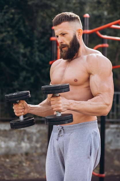 Premium Photo Muscular And Bearded Mustachioed Man Doing Exercises