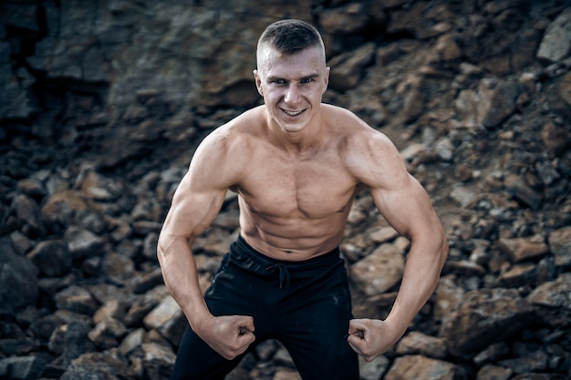 Premium Photo Muscular Guy With Naked Torso Posing With Tensed Hands