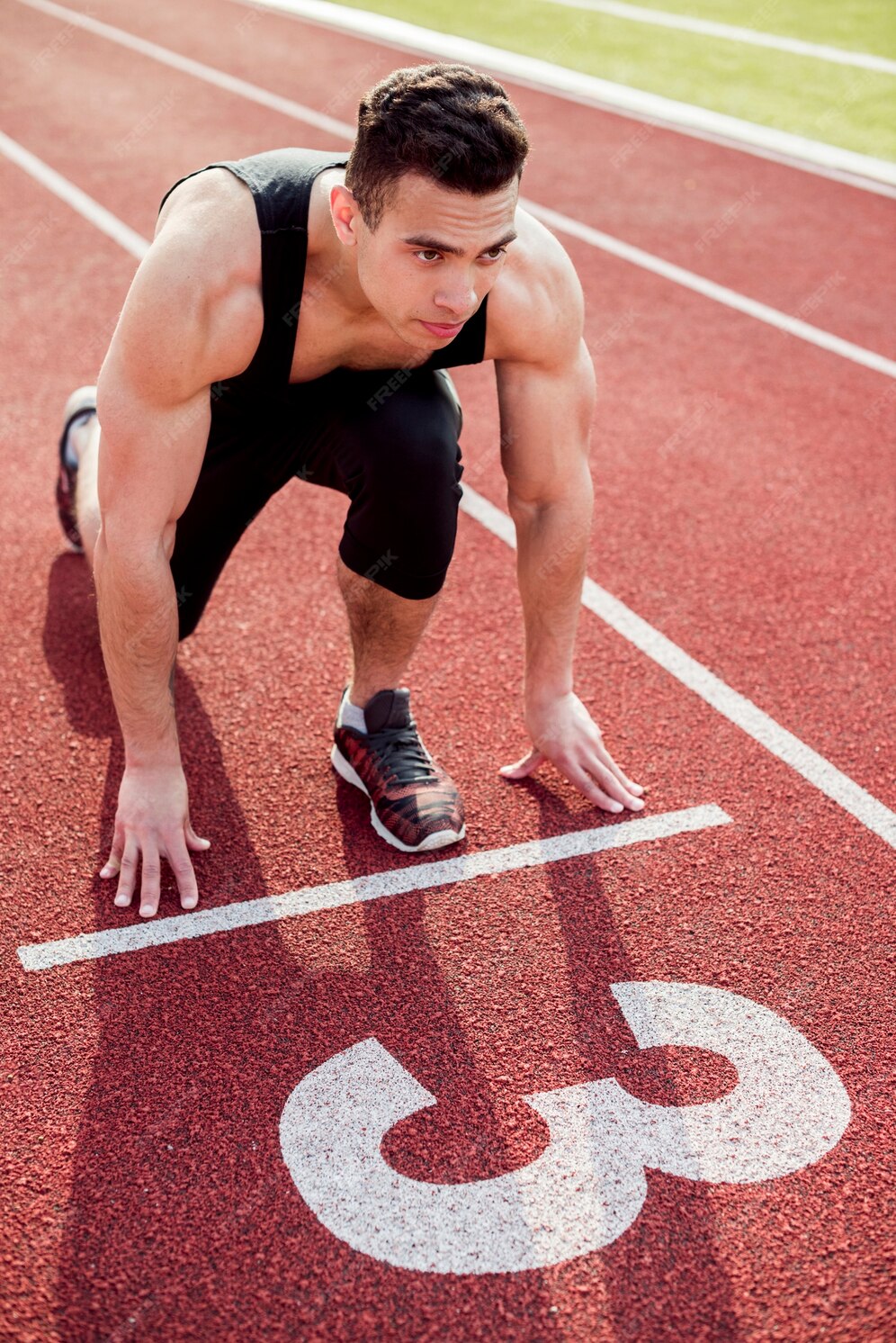 Free Photo | Muscular male young runner on the start line