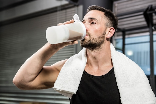 Premium Photo Muscular Man Drinking Protein Shake At The Crossfit Gym