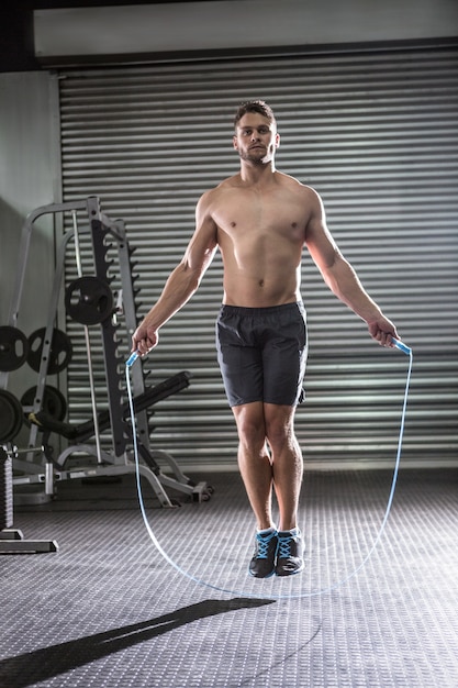 Premium Photo | Muscular man skipping