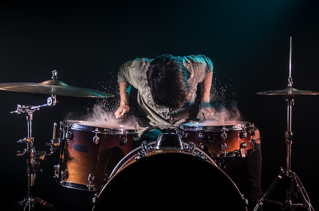 Free Photo | Musician playing drums with splashes, black background ...