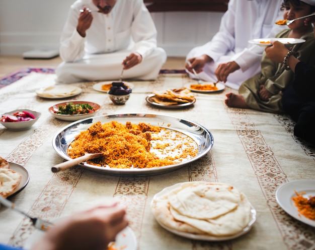 Muslim family having dinner on the floor Premium Photo
