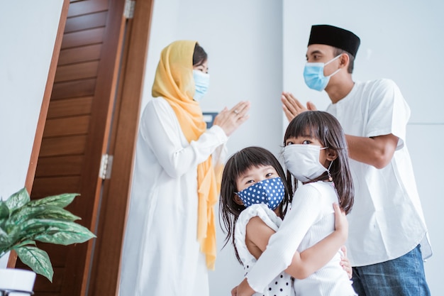 Muslim family visiting during eid mubarak celebration and wear mask for protection against corona virus Premium Photo