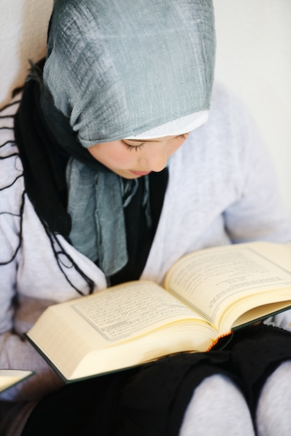 Premium Photo | Muslim kid reading koran