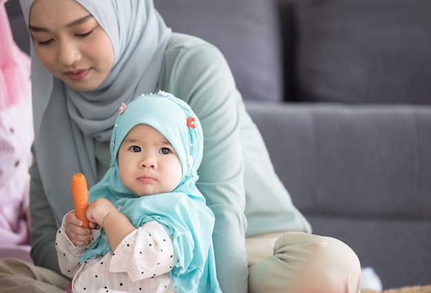 Premium Photo Muslim  mom  in hijab is her little daughter 