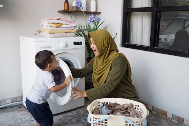 Premium Photo Muslim mother a housewife with a baby engaged in ... picture