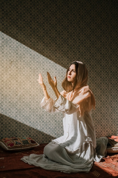 Free Photo Muslim woman praying  with sunlight effect