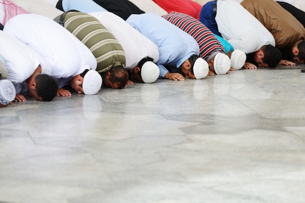 Premium Photo | Muslims praying together at holy mosque