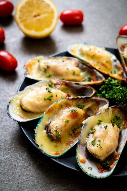 Premium Photo | Mussels baked with cheese