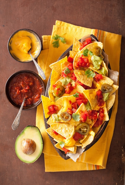 Premium Photo Nachos loaded with salsa cheese and jalapeno