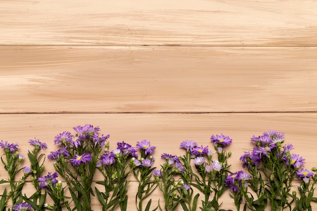 Natural purple flowers on wooden background Free Photo