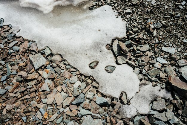 Premium Photo Nature Of Snow On Chaotic Pile Of Stones Natural Backdrop Of Ice On Random Boulders Firn On Combe Rock Close Up View From Above To Snowy Boulder Stream Minimalist Texture