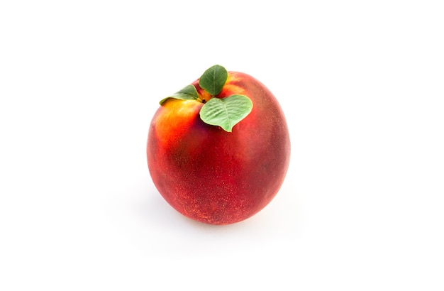 Premium Photo | Nectarine with leaf isolated on white.