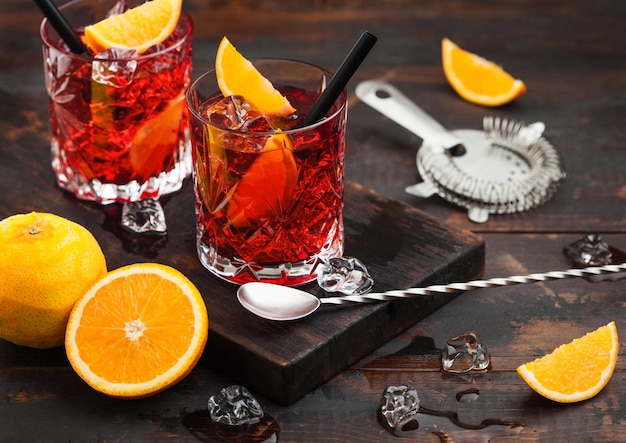 Premium Photo | Negroni cocktail in crystal glasses with orange slice ...